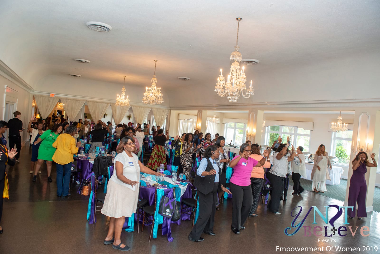 Wide view of community members gathered in the ballroom