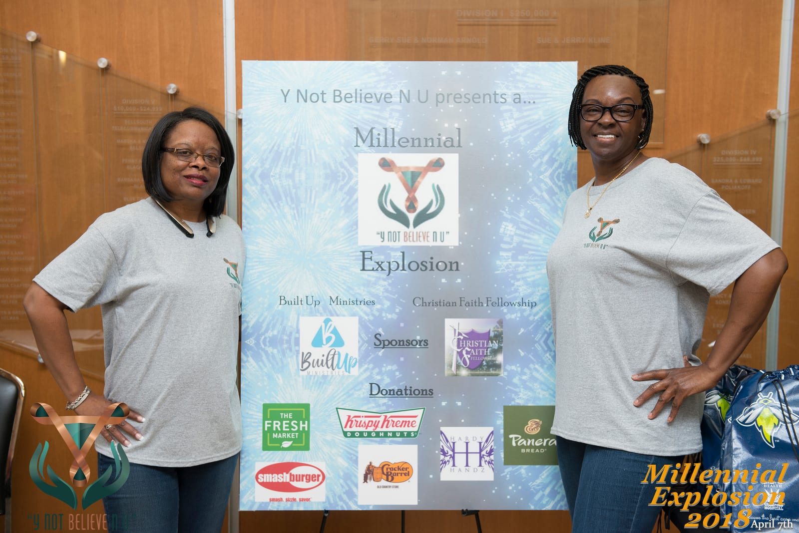 Two Y Not Believe event organizers standing beside the Millennial Explosion event display