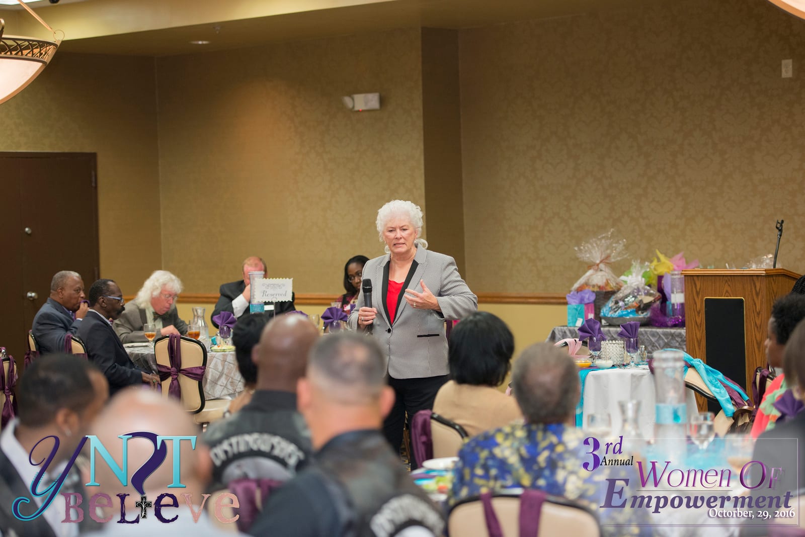 A guest speaker addressing the seated audience